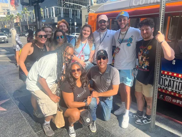 Happy guests from the Film Freak Movie Locations Tour posing on Hollywood Walk of Fame