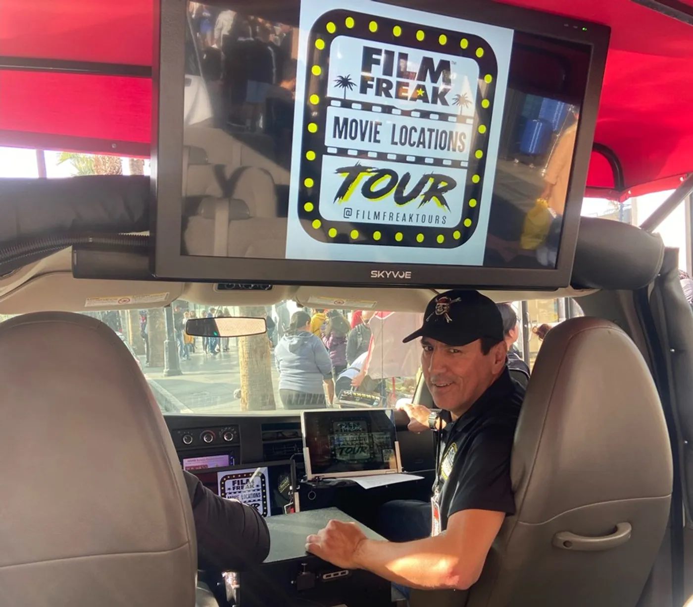 Leo Quinones inside the Film Freak tour van with big-screen TV playing movie clips at Hollywood filming locations